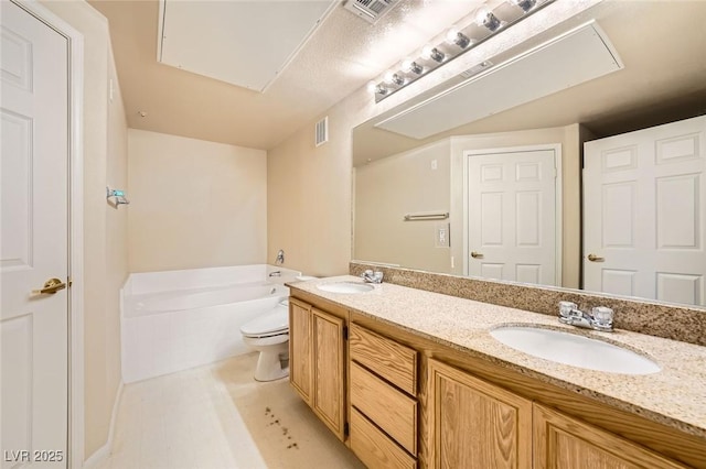 full bath with a garden tub, double vanity, and toilet
