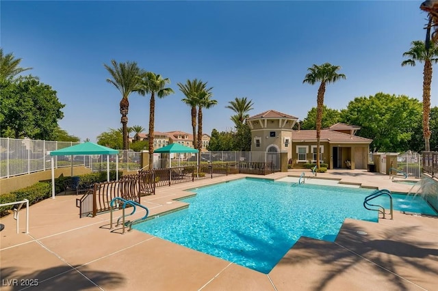 community pool featuring fence and a patio area