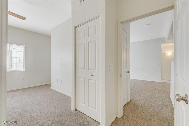 hall with light carpet and baseboards