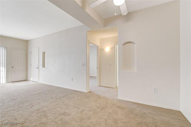 unfurnished room with carpet, a ceiling fan, and baseboards