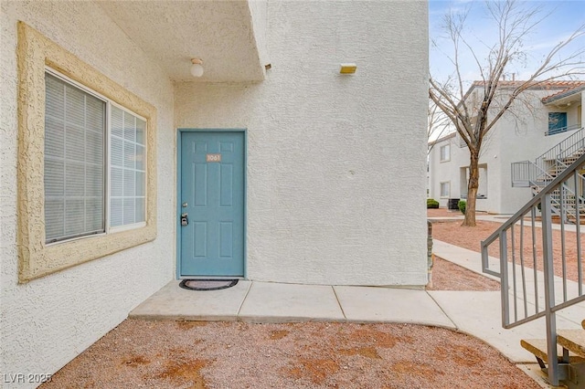 entrance to property with stucco siding