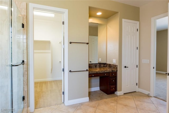 7434 Eggshell Dr, North Las Vegas, NV 89084 - full bathroom featuring a stall shower, vanity, baseboards, and a closet
