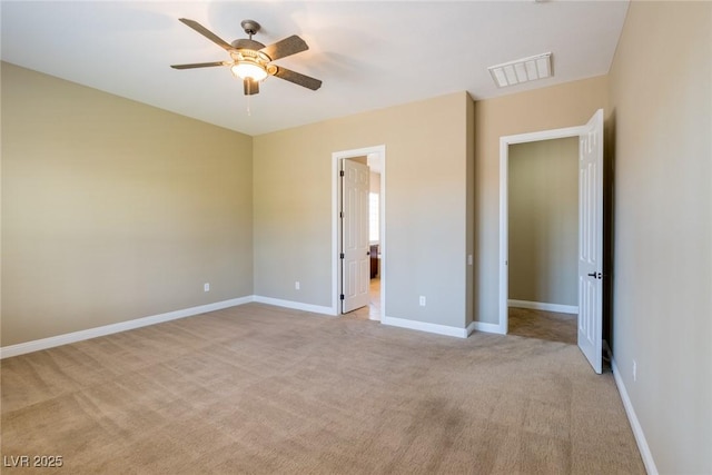 7434 Eggshell Dr, North Las Vegas, NV 89084 - unfurnished bedroom with light colored carpet, baseboards, a ceiling fan, and ensuite bathroom