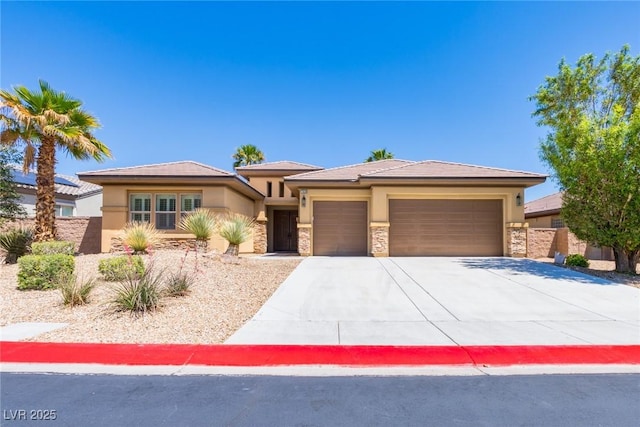7434 Eggshell Dr, North Las Vegas, NV 89084 - prairie-style home with stucco siding, a garage, concrete driveway, and stone siding