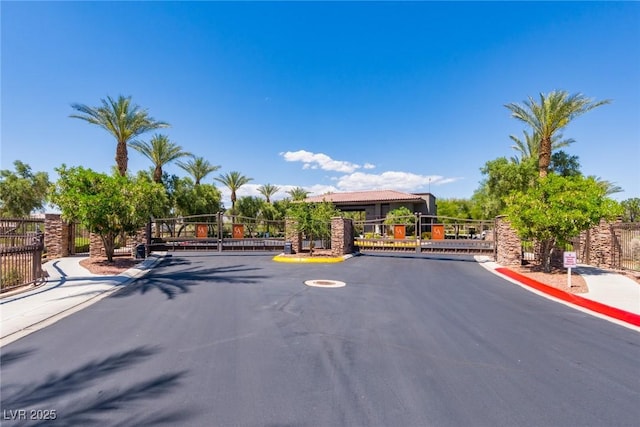 7434 Eggshell Dr, North Las Vegas, NV 89084 - view of asphalt street featuring a gate, curbs, and a gated entry