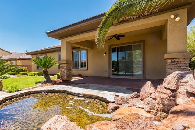 7434 Eggshell Dr, North Las Vegas, NV 89084 - back of house featuring stucco siding, ceiling fan, a patio area, and stone siding