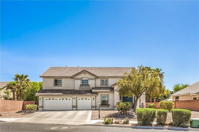 traditional-style house featuring fence, a garage, stucco siding, and concrete driveway