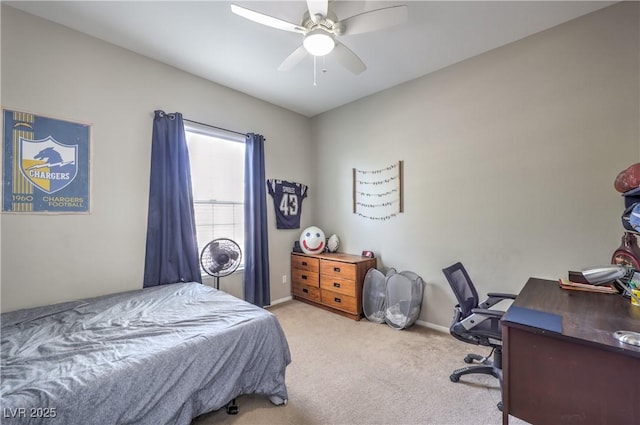 carpeted bedroom featuring baseboards, a desk, and ceiling fan