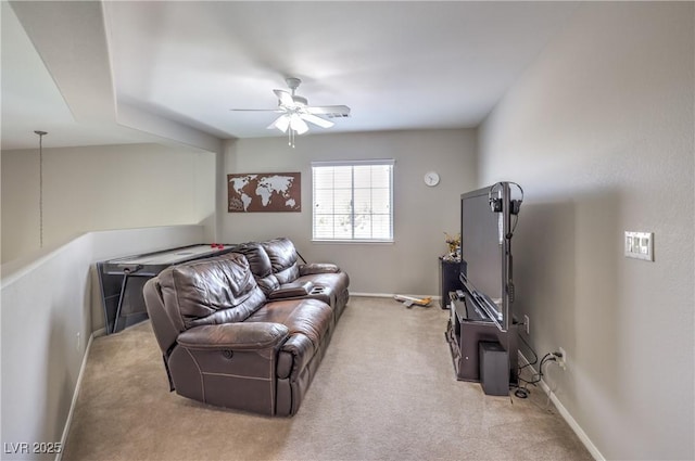 living room featuring a ceiling fan, light carpet, and baseboards