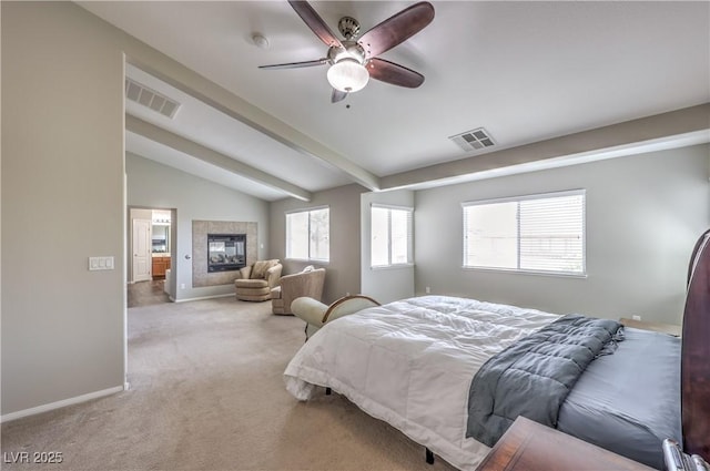 bedroom featuring carpet, a tile fireplace, baseboards, and a ceiling fan