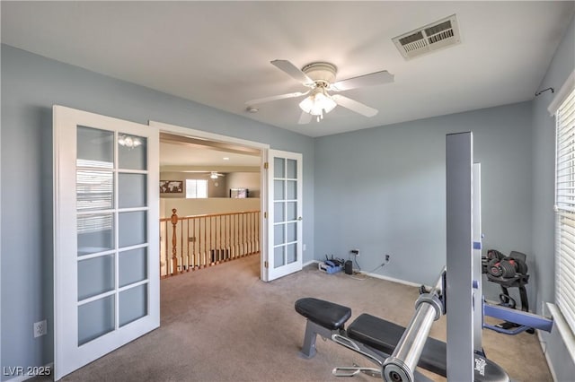 exercise room with french doors, ceiling fan, and carpet flooring