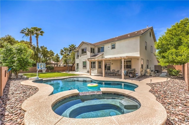 view of pool featuring a fenced backyard, a pool with connected hot tub, a grill, and a patio