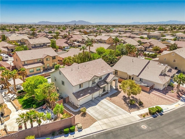 aerial view of residential area featuring mountains
