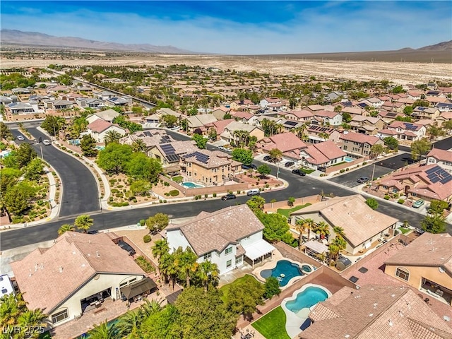 aerial perspective of suburban area featuring mountains and a pool area