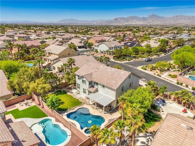 aerial view of residential area with a pool and mountains