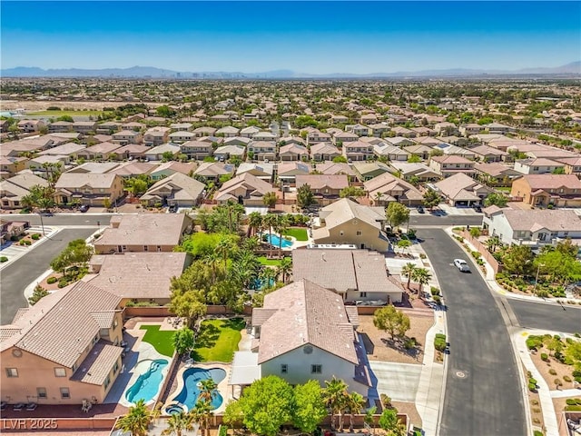aerial view of residential area with a pool and mountains
