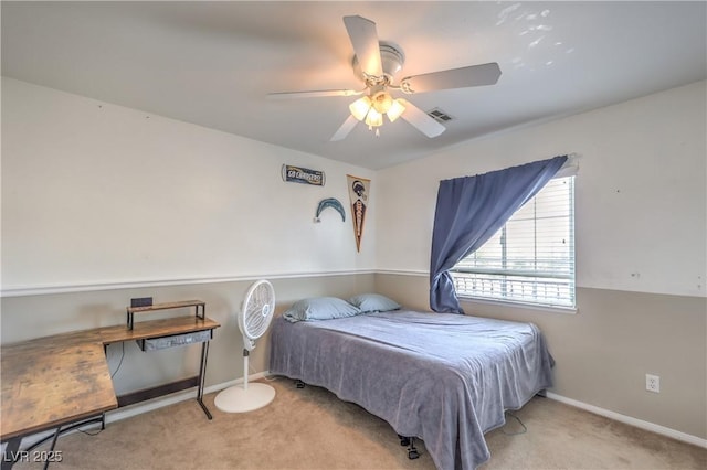 carpeted bedroom featuring baseboards and a ceiling fan