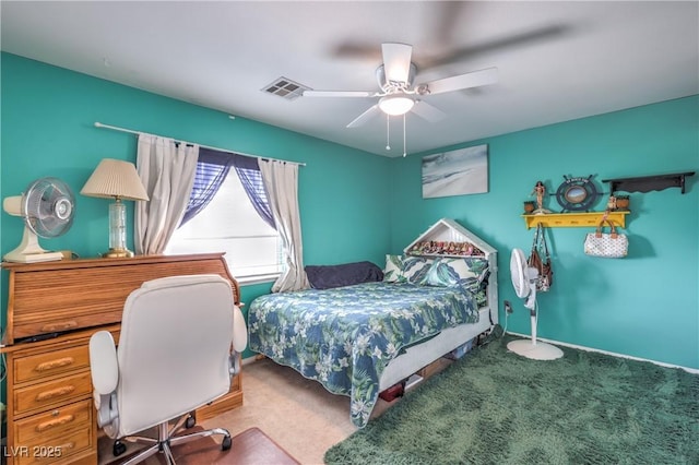 bedroom featuring carpet floors, a ceiling fan, and a desk