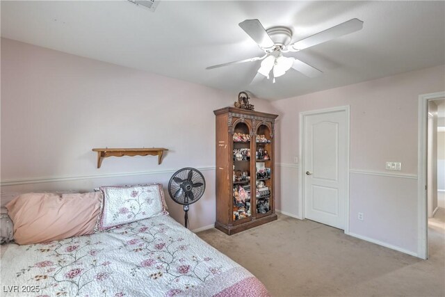 carpeted bedroom featuring a ceiling fan and baseboards
