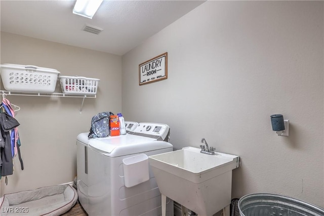 clothes washing area featuring separate washer and dryer