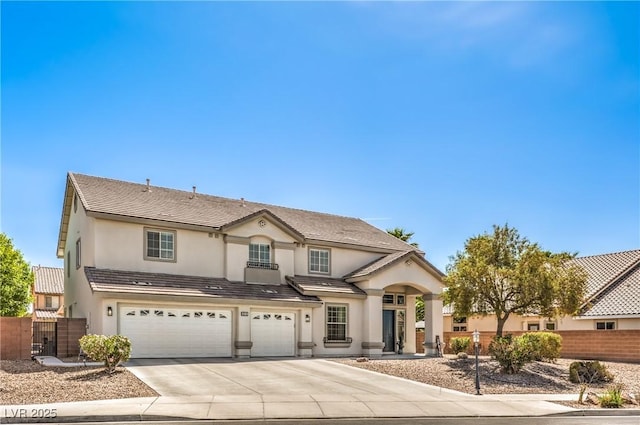view of front of home featuring an attached garage, fence, driveway, and stucco siding