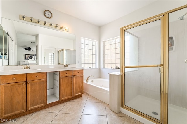 bathroom featuring double vanity, a stall shower, a bath, and tile patterned flooring