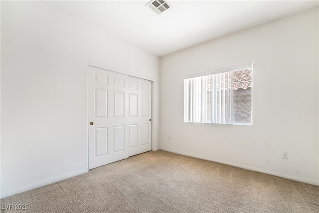 unfurnished bedroom with carpet floors and baseboards
