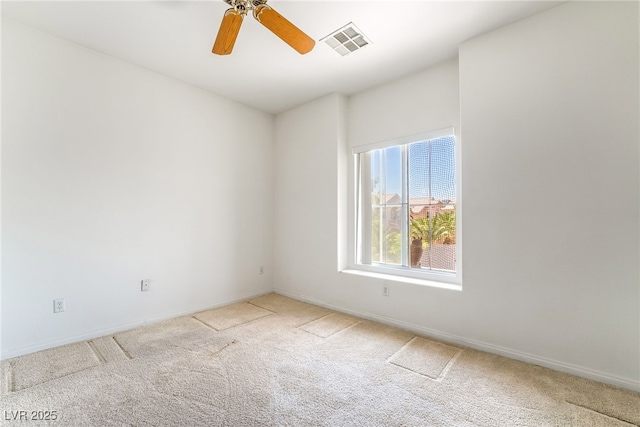unfurnished room featuring carpet, baseboards, and a ceiling fan