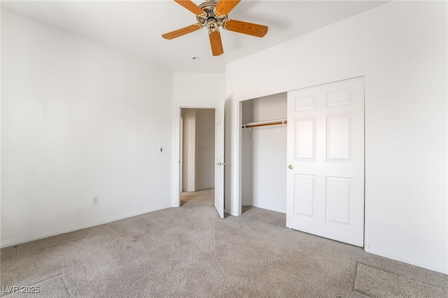 unfurnished bedroom with light colored carpet, a closet, baseboards, and a ceiling fan