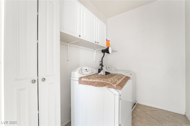 washroom with independent washer and dryer, baseboards, and light tile patterned floors
