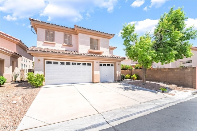mediterranean / spanish house featuring a garage, a tile roof, driveway, stucco siding, and fence