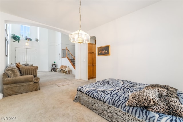 bedroom with a chandelier, light colored carpet, arched walkways, and a high ceiling
