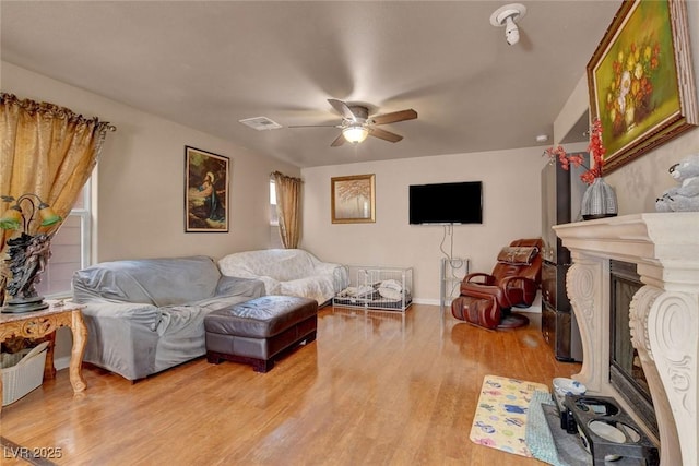 9065 W Torino Ave, Las Vegas, NV 89148 - living area with a ceiling fan, light wood-type flooring, and a glass covered fireplace