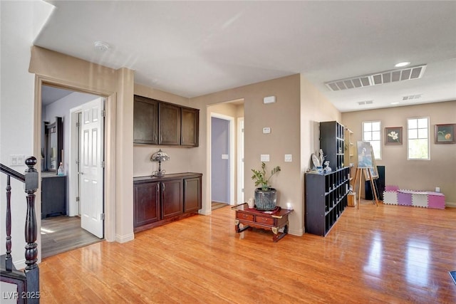 9065 W Torino Ave, Las Vegas, NV 89148 - kitchen with light wood-style flooring, dark brown cabinetry, and baseboards