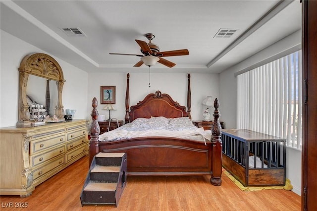 9065 W Torino Ave, Las Vegas, NV 89148 - bedroom featuring a raised ceiling and light wood-type flooring