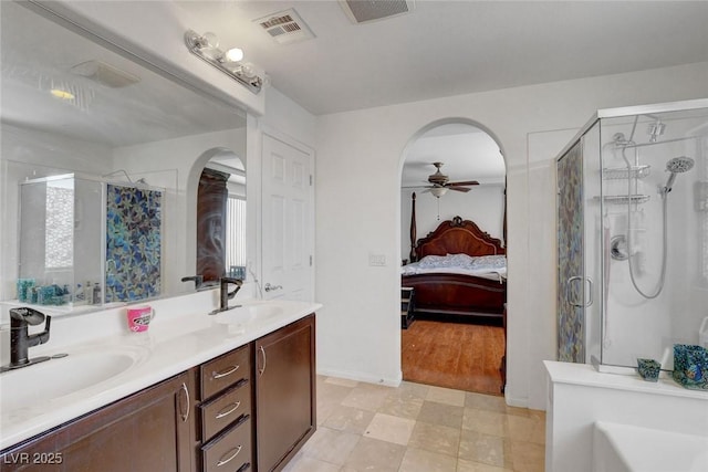 9065 W Torino Ave, Las Vegas, NV 89148 - full bath with a shower stall, a ceiling fan, double vanity, and ensuite bath