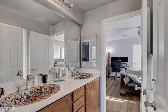 9065 W Torino Ave, Las Vegas, NV 89148 - ensuite bathroom featuring wood finished floors, vanity, and ceiling fan