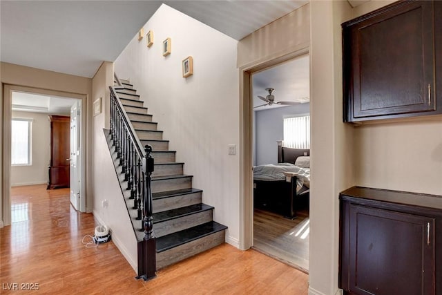 9065 W Torino Ave, Las Vegas, NV 89148 - stairs featuring wood finished floors, healthy amount of natural light, a ceiling fan, and baseboards