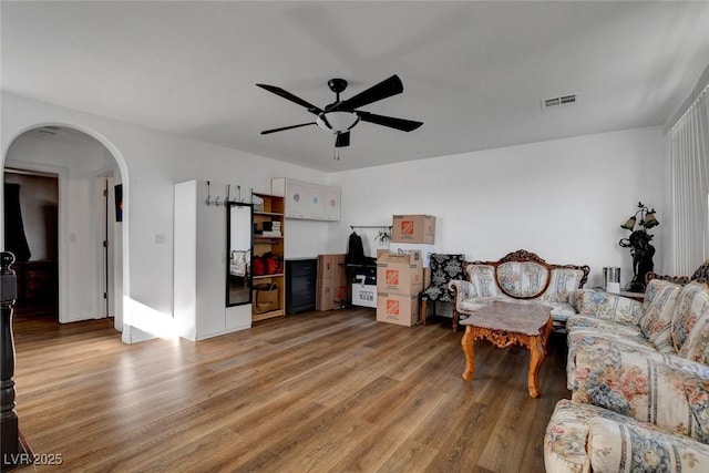 9065 W Torino Ave, Las Vegas, NV 89148 - living area featuring arched walkways, light wood-style flooring, and ceiling fan