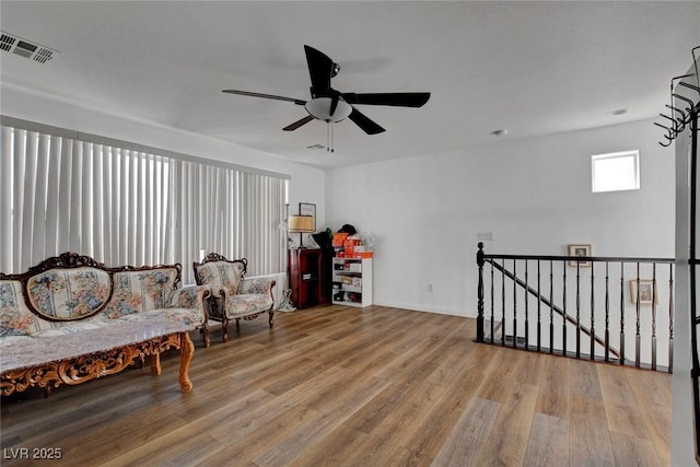9065 W Torino Ave, Las Vegas, NV 89148 - living area with an upstairs landing, wood finished floors, ceiling fan, and baseboards