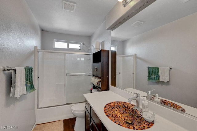 9065 W Torino Ave, Las Vegas, NV 89148 - bathroom with toilet, vanity, enclosed tub / shower combo, wood finished floors, and baseboards