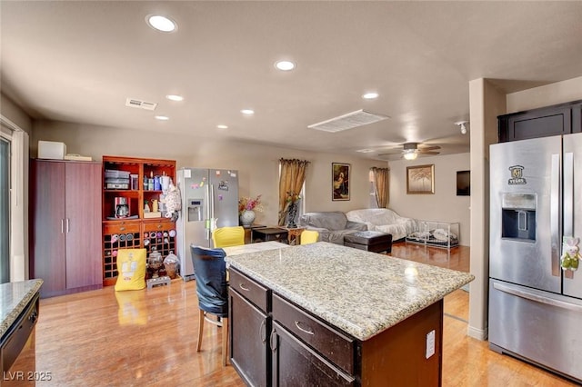 9065 W Torino Ave, Las Vegas, NV 89148 - kitchen featuring stainless steel refrigerator with ice dispenser, light wood-type flooring, light stone countertops, a kitchen island, and recessed lighting