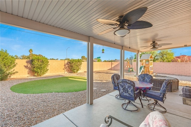 2720 Mickey Mantle Ct, Las Vegas, NV 89108 - fenced backyard with a playground, a ceiling fan, a patio, and outdoor dining area