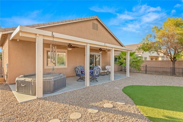 2720 Mickey Mantle Ct, Las Vegas, NV 89108 - rear view of house with ceiling fan, a hot tub, stucco siding, and a patio