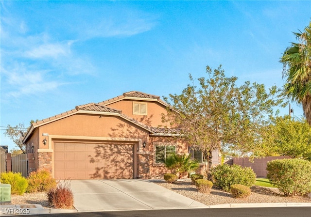 2720 Mickey Mantle Ct, Las Vegas, NV 89108 - view of front of home with an attached garage, concrete driveway, a tile roof, and stucco siding