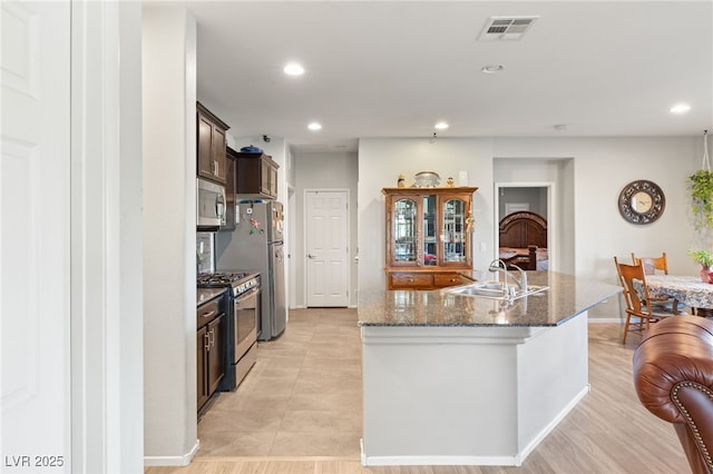 2720 Mickey Mantle Ct, Las Vegas, NV 89108 - kitchen featuring stainless steel appliances, a sink, recessed lighting, an island with sink, and dark brown cabinets