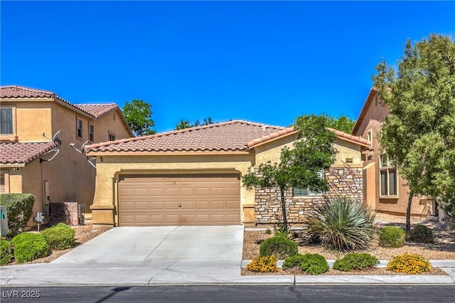 view of front of home with a garage, concrete driveway, stucco siding, and a tiled roof