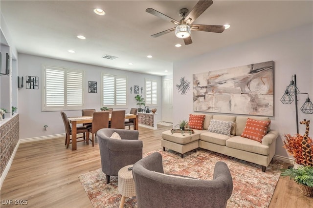 living area with ceiling fan, baseboards, light wood-type flooring, and recessed lighting