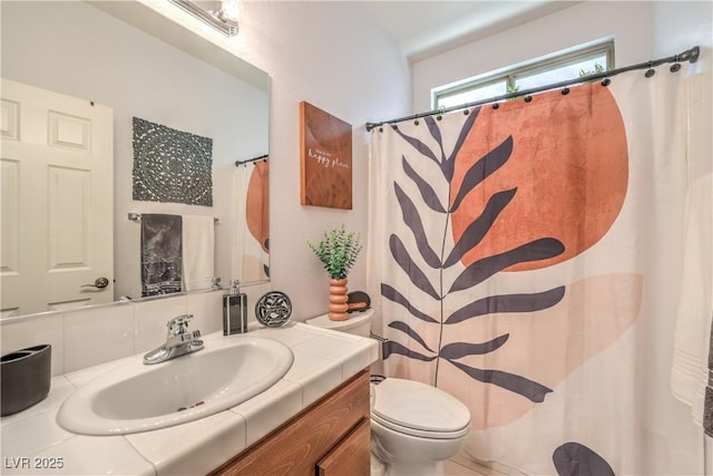 full bathroom featuring toilet, vanity, and a shower with shower curtain