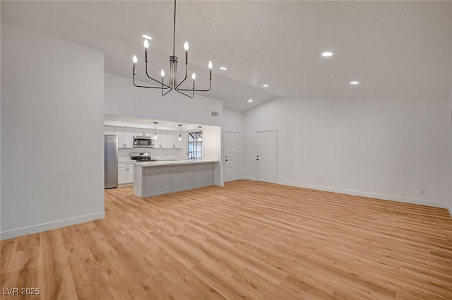 8412 Mulcahy Ave, Las Vegas, NV 89145 - unfurnished living room featuring a chandelier, vaulted ceiling, recessed lighting, light wood-style flooring, and baseboards